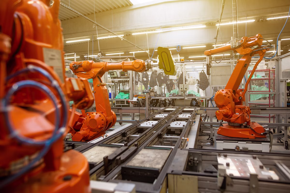 Robot arms on a factory automation production line supplying protocol-level signals through industrial data connectivity within industrial automation