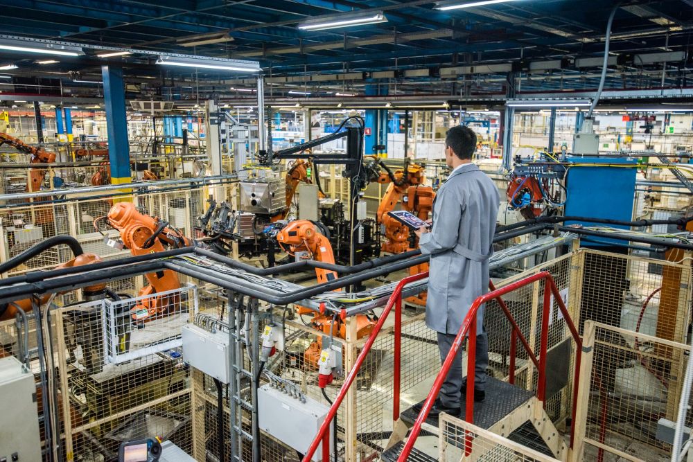 Robots working in a factory whose raw signals are mapped to industrial automation production context by protocol-level drivers